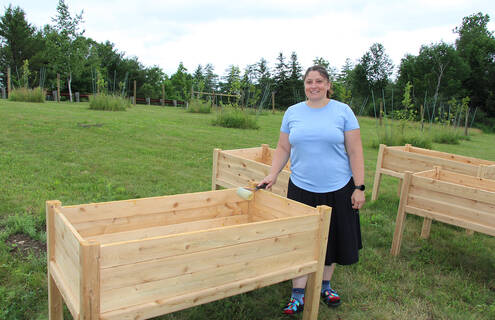 Taralyn Bielaski, MPH standing at the Farmacy Garden